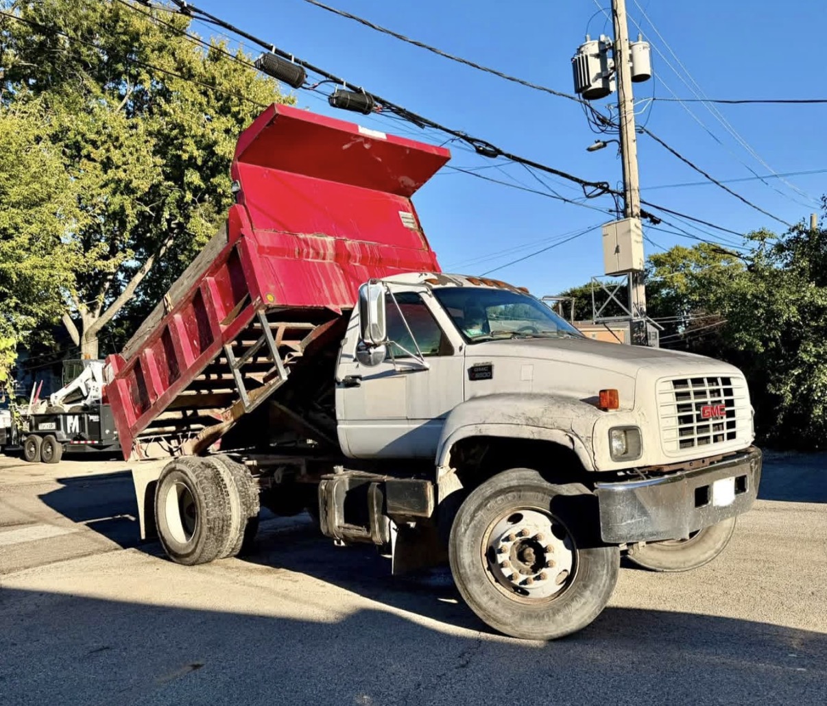 Our white GMC dump truck with its red dump bed raised